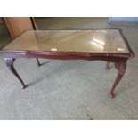 A reproduction coffee table with tooled leather insert to top