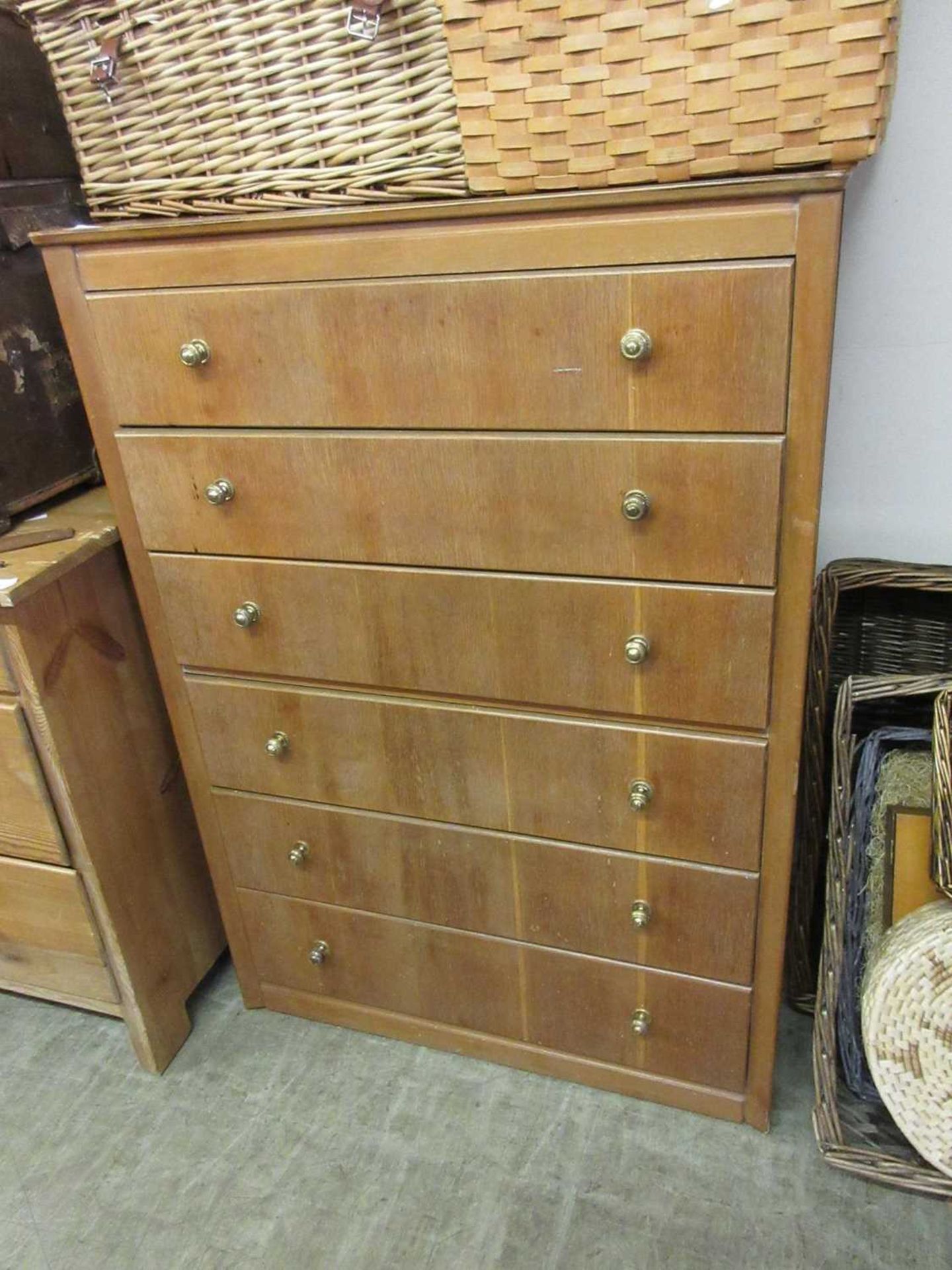 A mid-20th century oak veneered chest of six long drawers