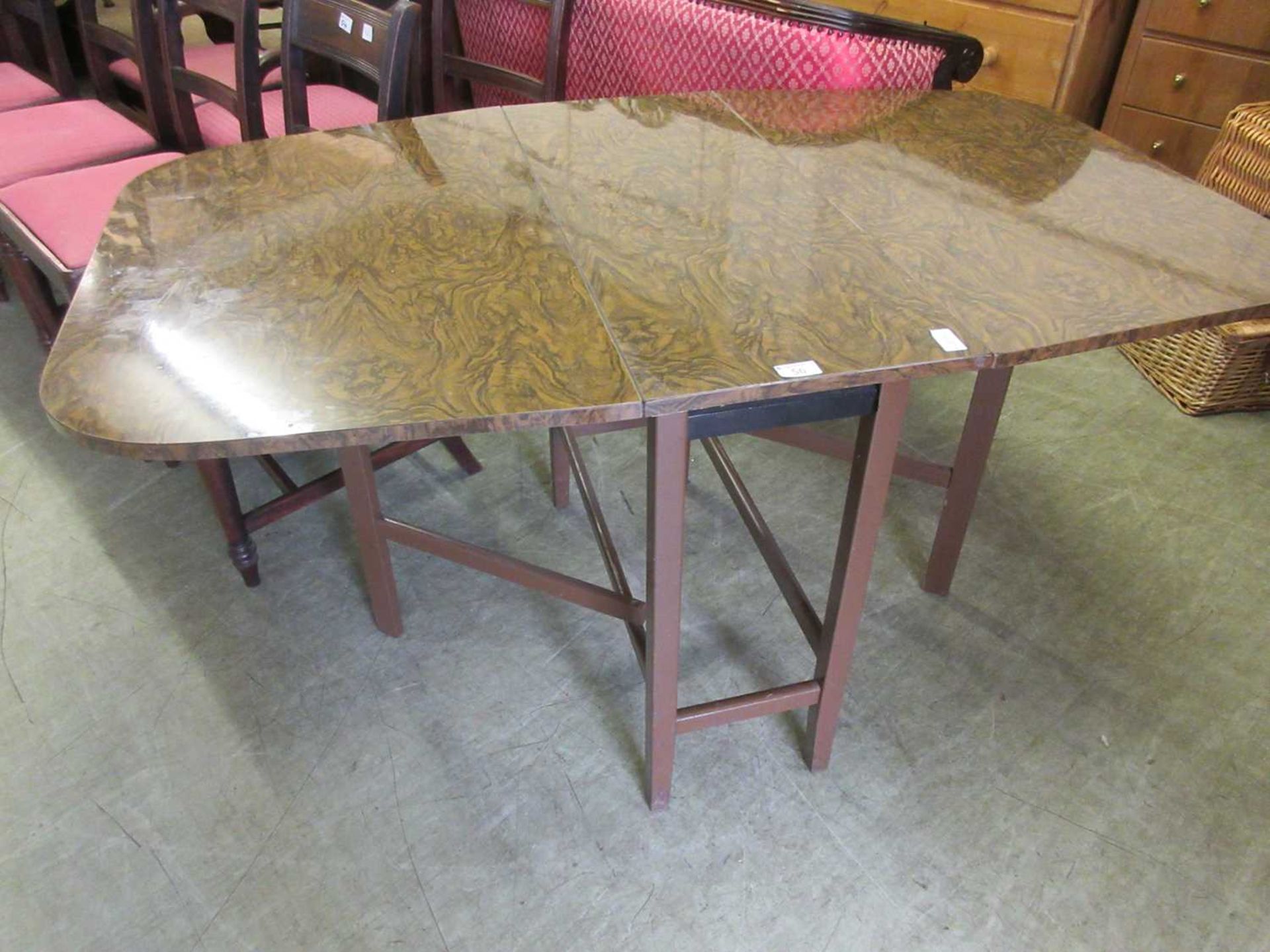 A mid-20th century faux burr walnut topped drop leaf kitchen table