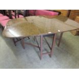 A mid-20th century faux burr walnut topped drop leaf kitchen table