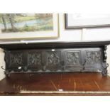 A 19th century oak wall hanging coat rack with floral carved panels