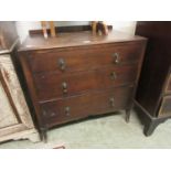 An early 20th century oak chest of three long drawers