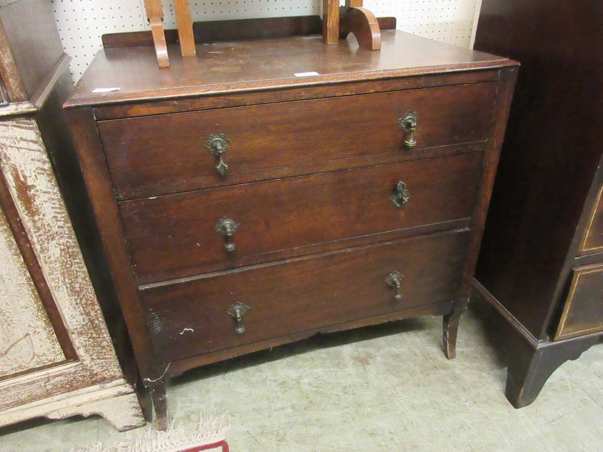 An early 20th century oak chest of three long drawers