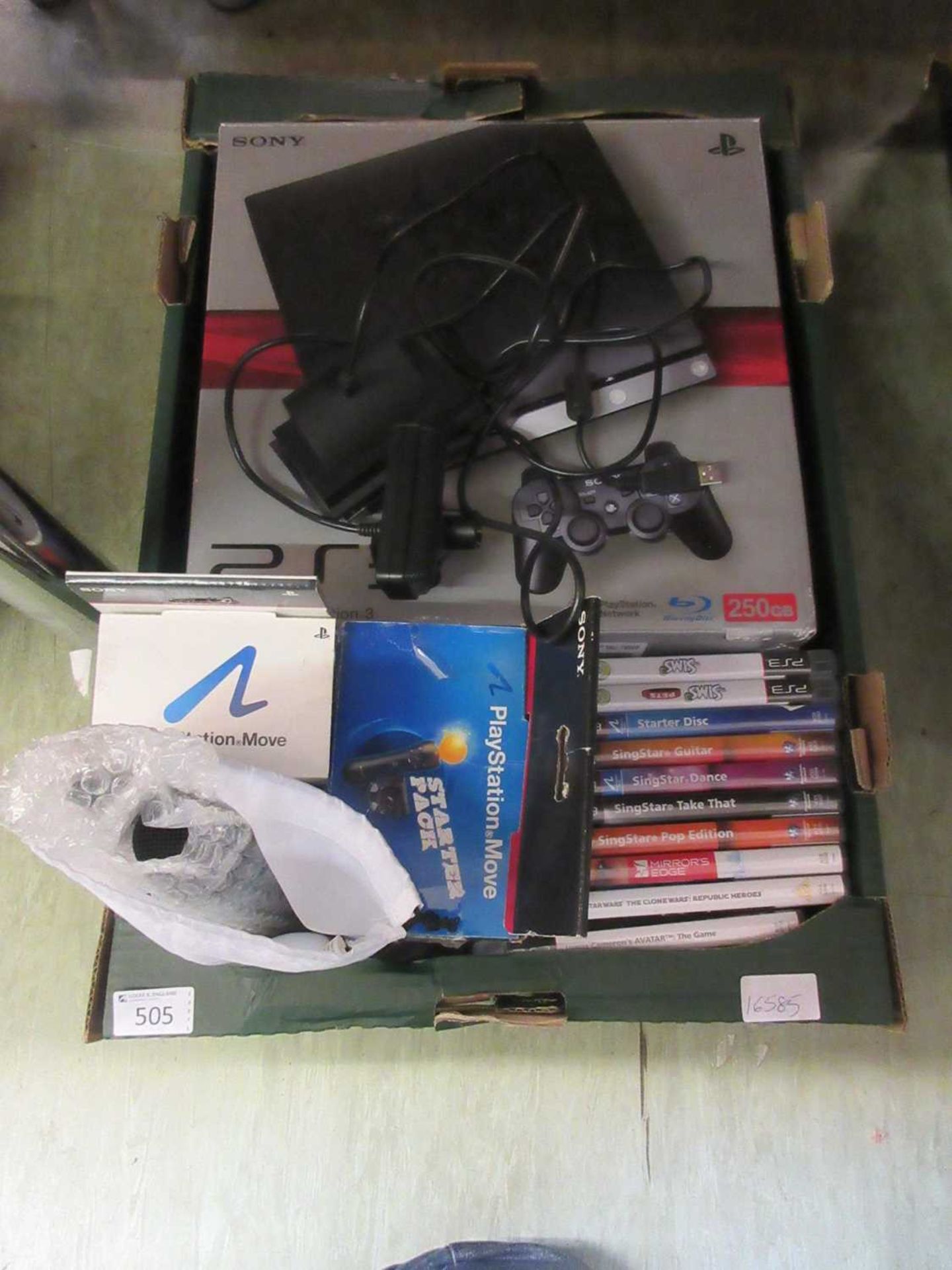 A box containing a Sony Playstation 3 with an assortment of games and accessories to include