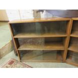 A mid-20th century oak bookcase with glazed sliding doors