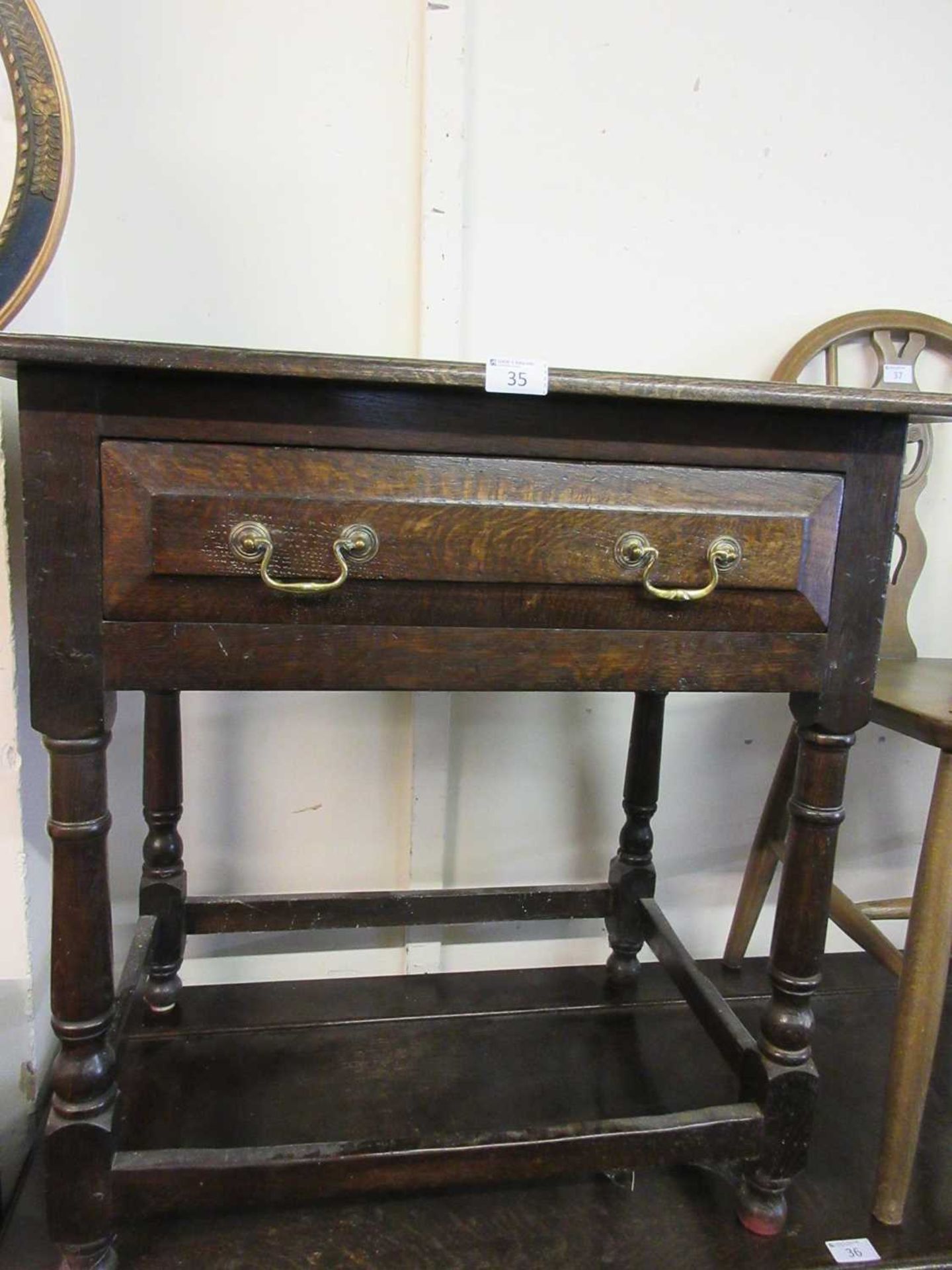 A reproduction oak 18th century style single drawer side table