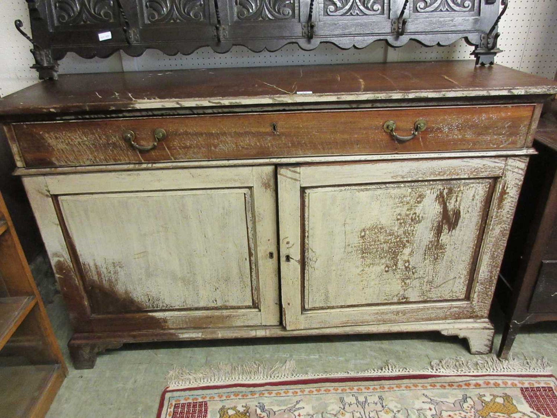 An early 20th century mahogany sideboard, the top over one long drawer and two cupboard doors with