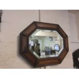 An early 20th century oak bevel glass mirror