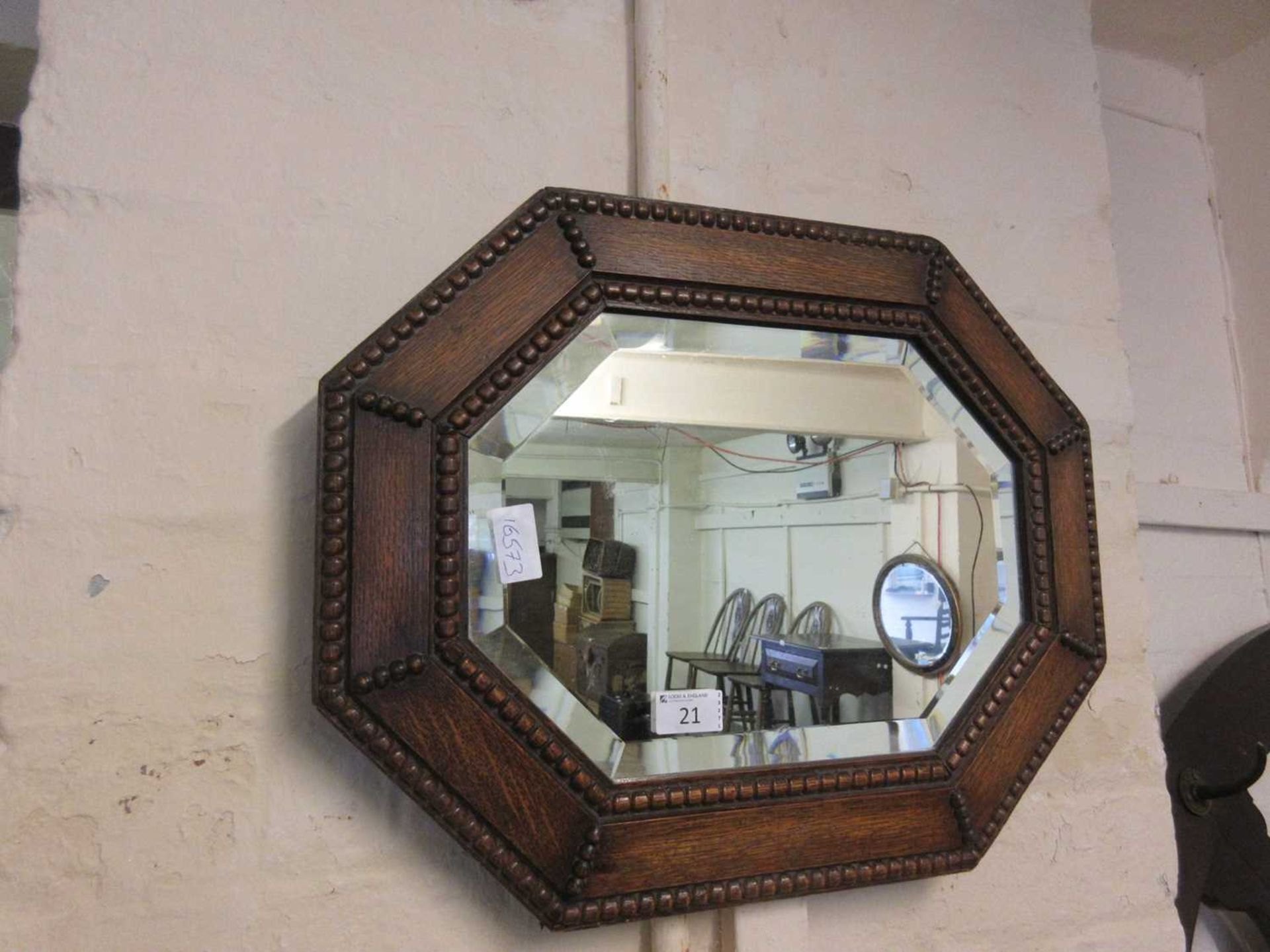 An early 20th century oak bevel glass mirror