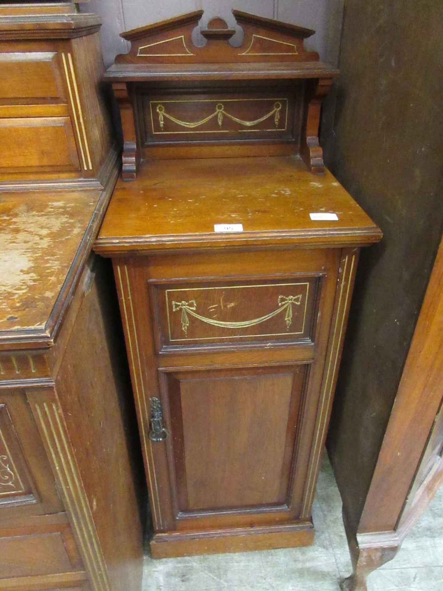 An early 20th century walnut and parcel gilt pot cupboard
