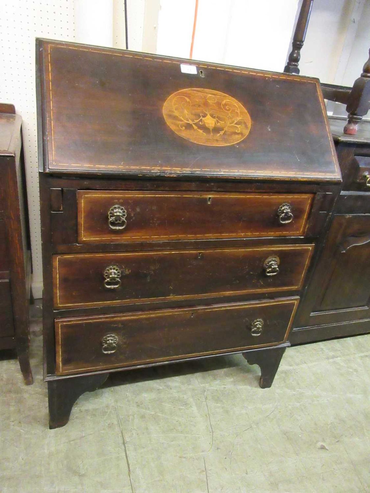 An early 20th century mahogany, strung, and marquetry bureau
