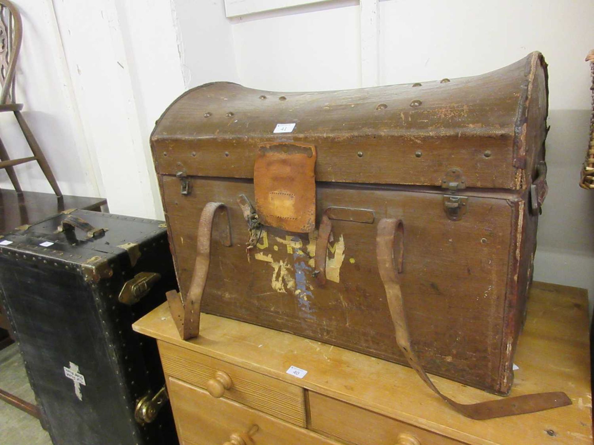 An early 20th century oil skin and leather travelling trunk with fitted interior having name J.R.