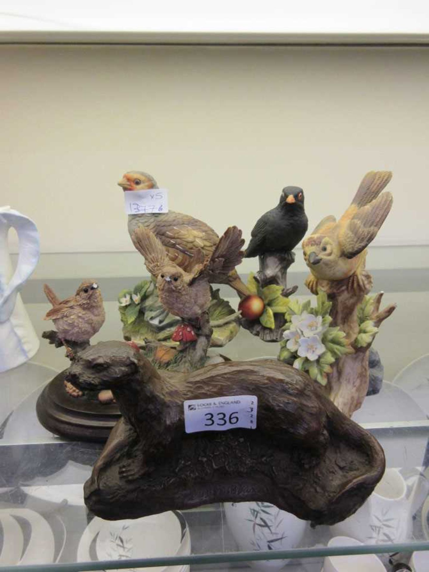 Four models of birds along with an otter