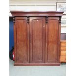 A Victorian mahogany three door wardrobe, the interior with slides, drawers and hanging space
