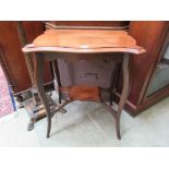 An Edwardian walnut serpentine topped occasional table