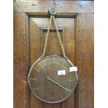 An early 20th century walnut convex wall clock with rope design