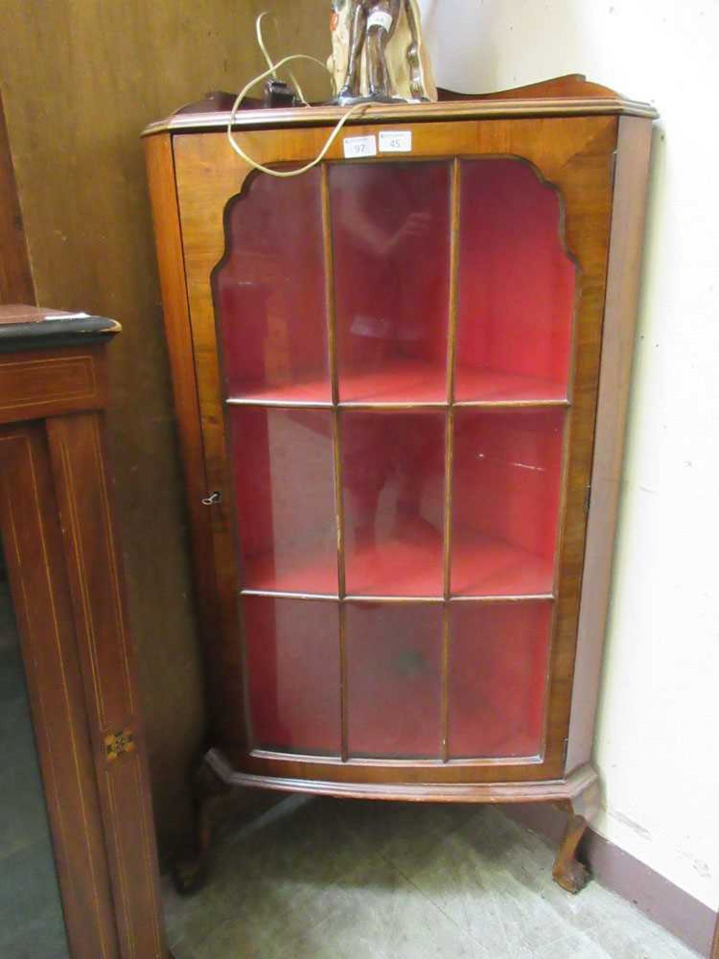 An early 20th century walnut floor standing corner display cupboard (A/F)