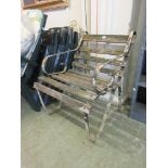 A wrought iron antique slatted garden bench