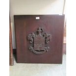 A carved mahogany armorial crest on board