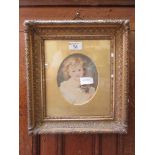 An ornate gilt framed enhanced print of child with cat