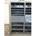 A grey metal worktop unit comprising of pigeon holes, drawers and shelves