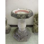 A composite stone garden bird bath