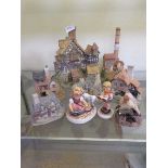 A collection of David Winter cottages and two Hummel figures