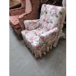 An early 20th century child's armchair with floral fabric