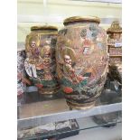 A pair of early 20th century Japanese ceramic vases with gilt figural decoration Height: 37cm