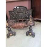 A reproduction armorial cast iron fireback along with fire grate and dogs Dimensions: 36cm (H) x