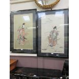 A pair of framed and glazed oriental needlework of figures