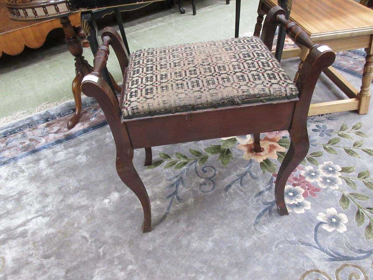 An early 20th century walnut music stool