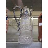 A silver plated and cut glass claret jug
