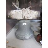 A bronze bell on wooden fixture