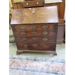 A late 18th century mahogany bureau, the fall front enclosing a carved fitted interior with secret