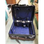 An early 20th century leather travelling vanity case with silver hallmarked accessories by Z