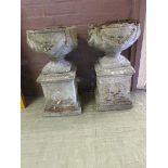 A pair of composite stone garden pots on plinths Height: 74cm