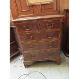 A reproduction yew veneered chest of two short over three long drawers