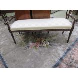 A reproduction 18th century style mahogany foot stool upholstered in a patterned white gold fabric