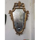 An ornate gilt framed mirror