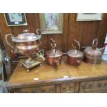 Three copper kettles together with a copper water urn
