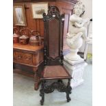 A 19th century oak high back chair with bergere seat and back