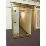 A large gilt framed bevel glass mirror