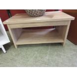 An oak effect coffee table with under tier