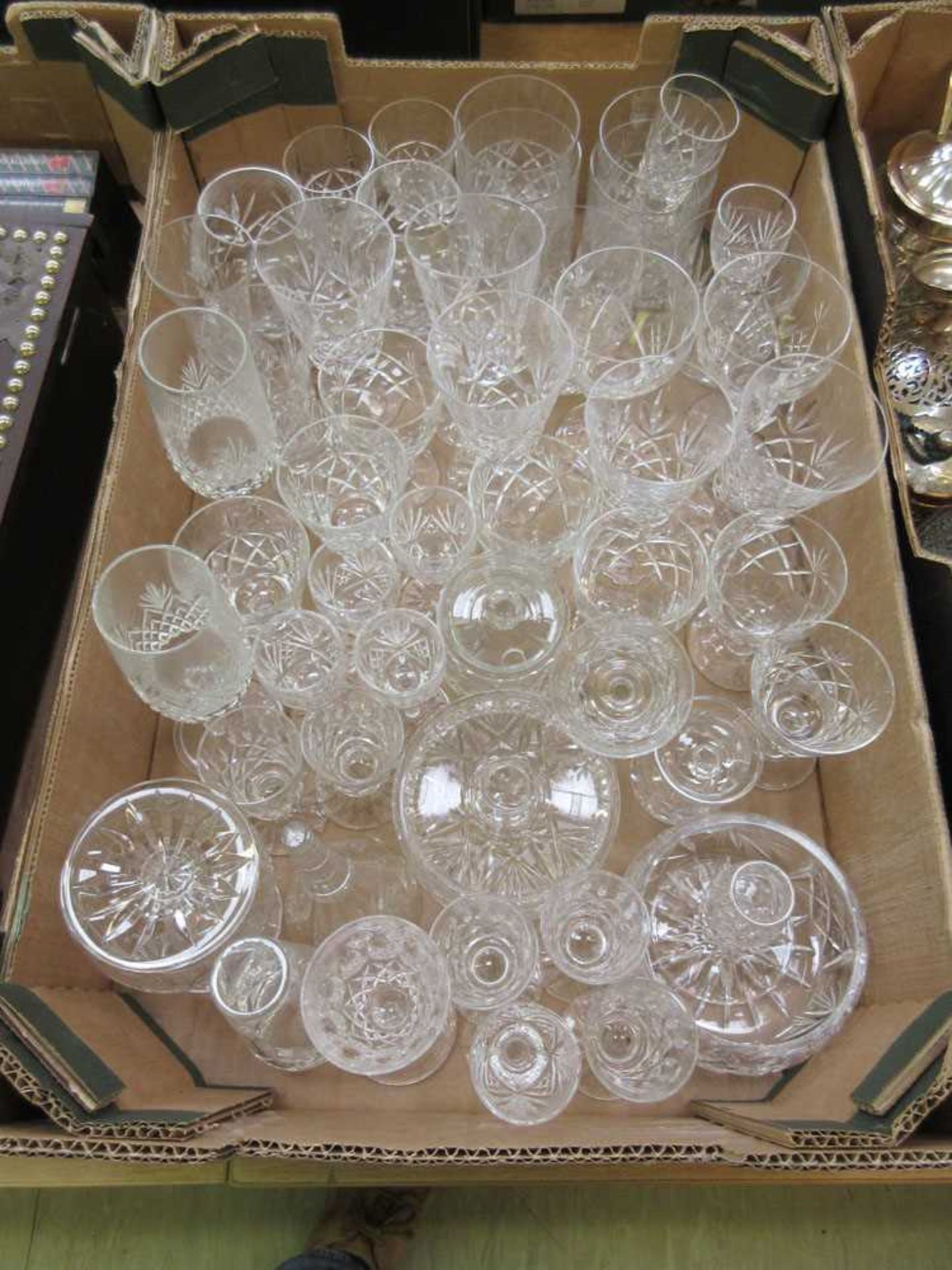 A tray containing cut glassware to include champagne glutes, wine glasses, etc