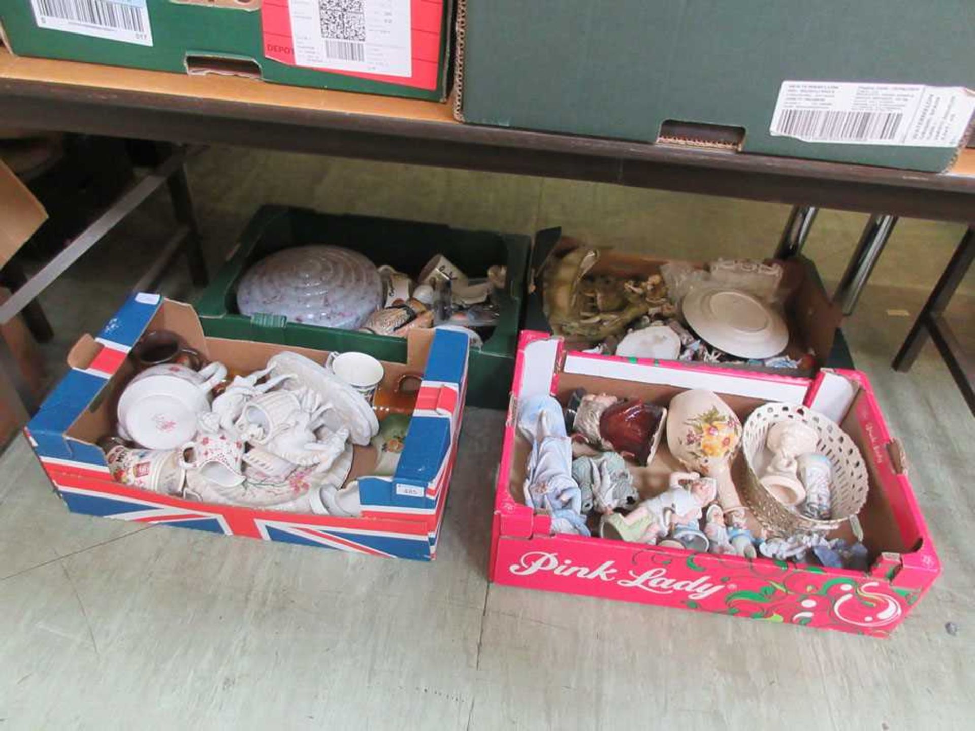 Four trays of ceramic and glassware to include figurines, coffee mugs, mid-20th century style