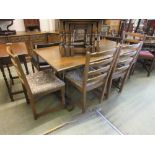 An oak dining table on trestle end supports along with a set of four matching chairs