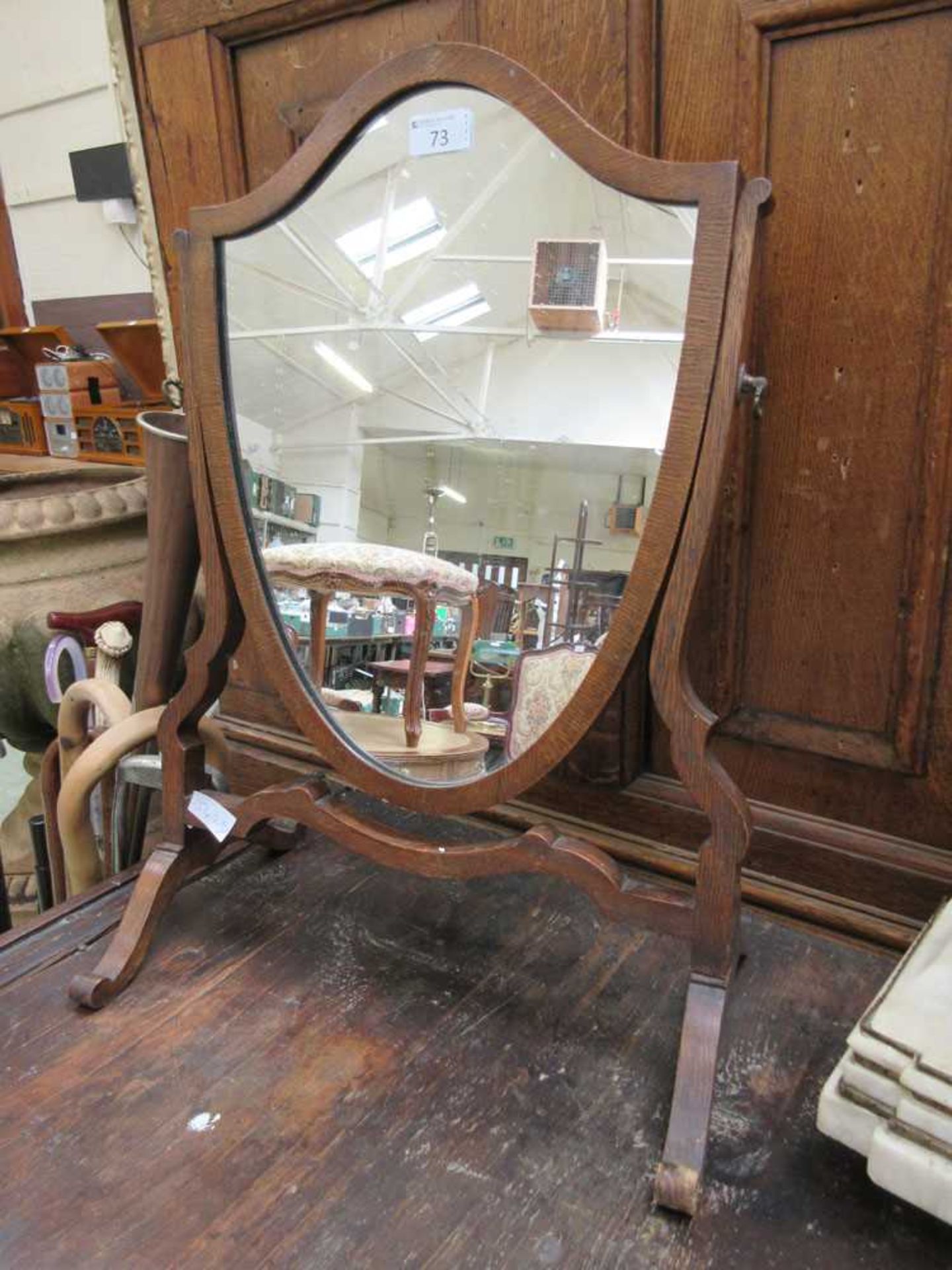 A 19th century oak framed shield toilet mirror