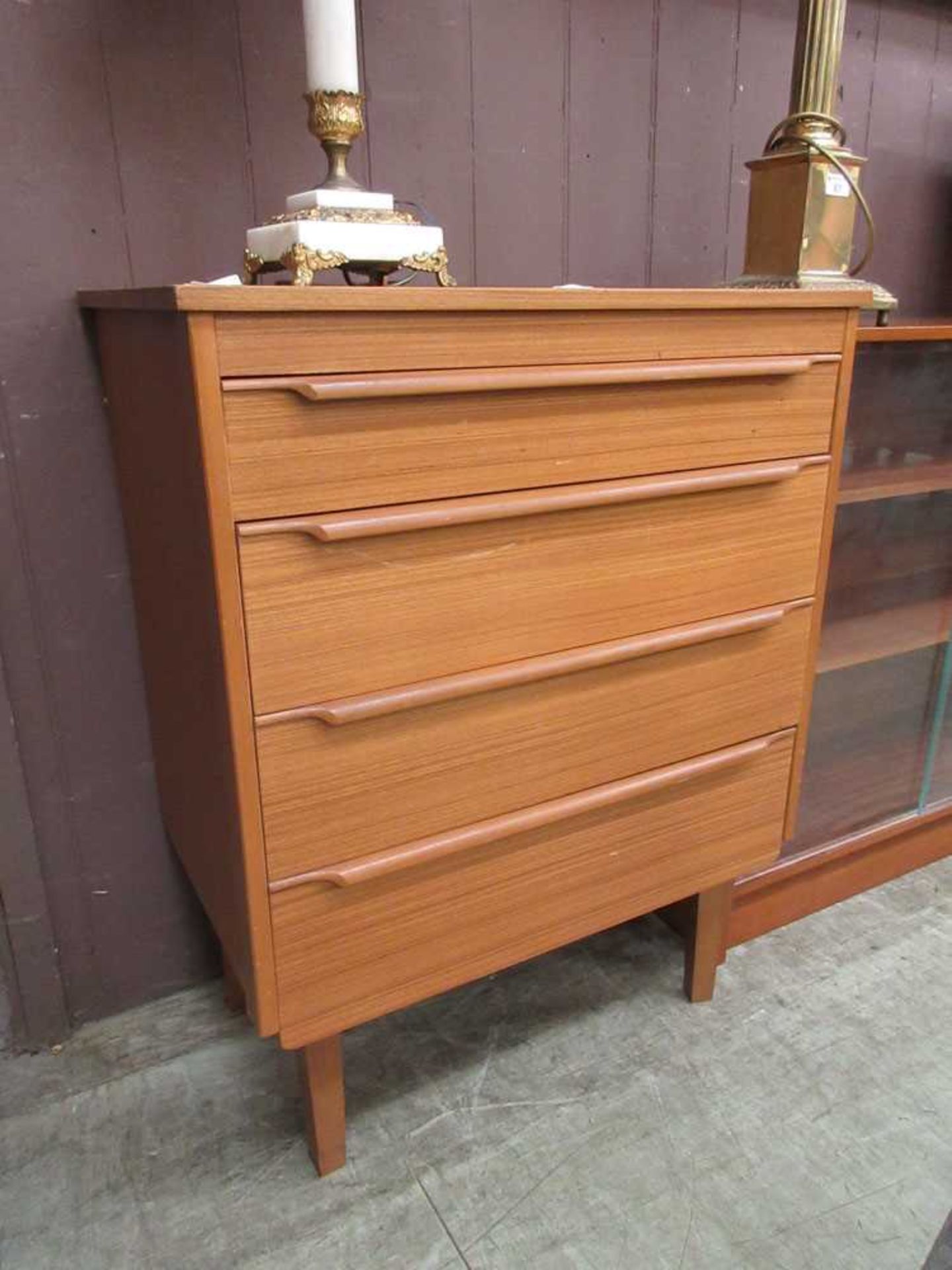 A mid-20th century teak chest of four drawers