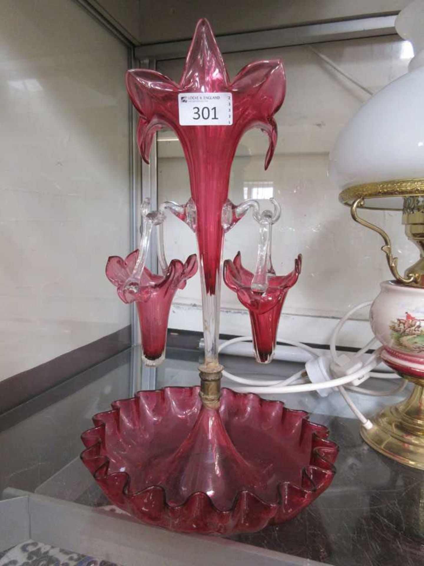 A cranberry glass epergne Multiple damages and repairs present, photos for reference available.